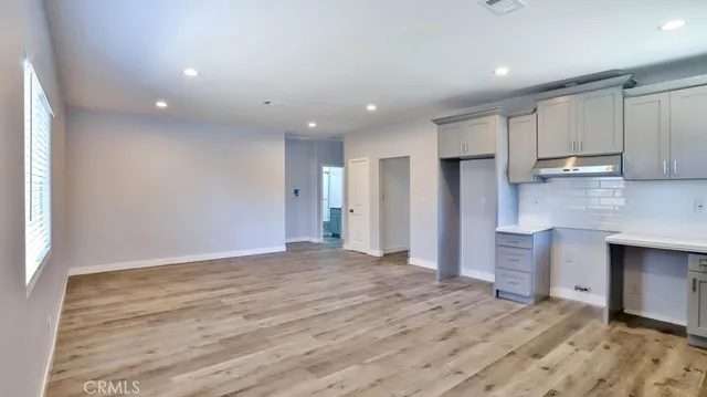 a view of a kitchen with a sink and dishwasher cabinets
