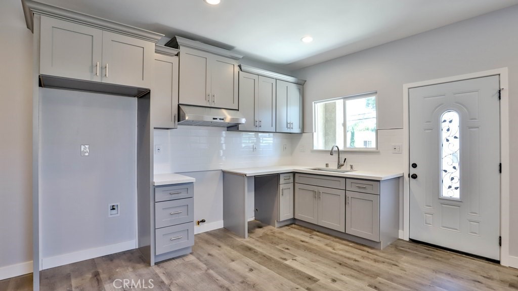1246 South Baker Street Santa Ana, CA 92707 - Photo 9 of 19 a kitchen with stainless steel appliances granite countertop a stove and a sink