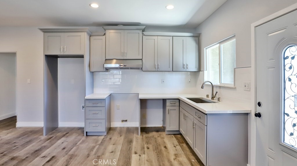 1246 South Baker Street Santa Ana, CA 92707 - Photo 10 of 19 a kitchen with granite countertop a sink stove and cabinets