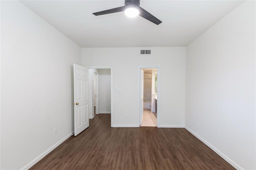 12680 Hillcrest Road, Unit 4101 Dallas, TX 75230 - Photo 27 of 37 Bright interior space featuring wood-finish flooring, a contemporary ceiling fan, and white walls