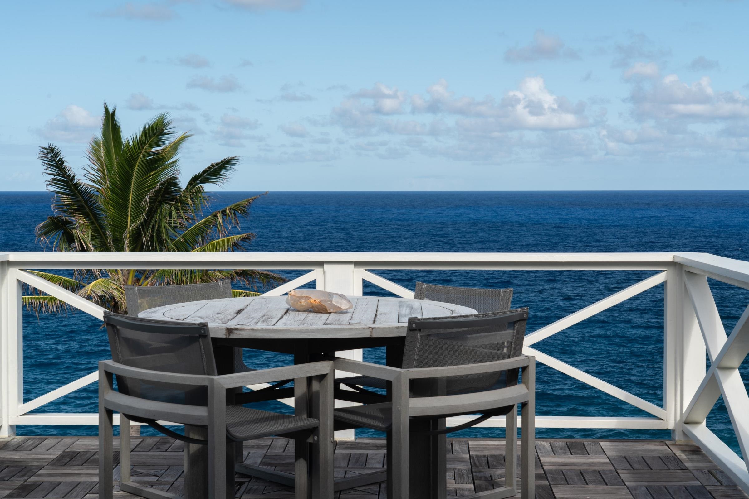 51 Kapohue Road Hana, HI 96713 - Photo 39 of 50 a roof deck with table and chairs potted plants with wooden floor