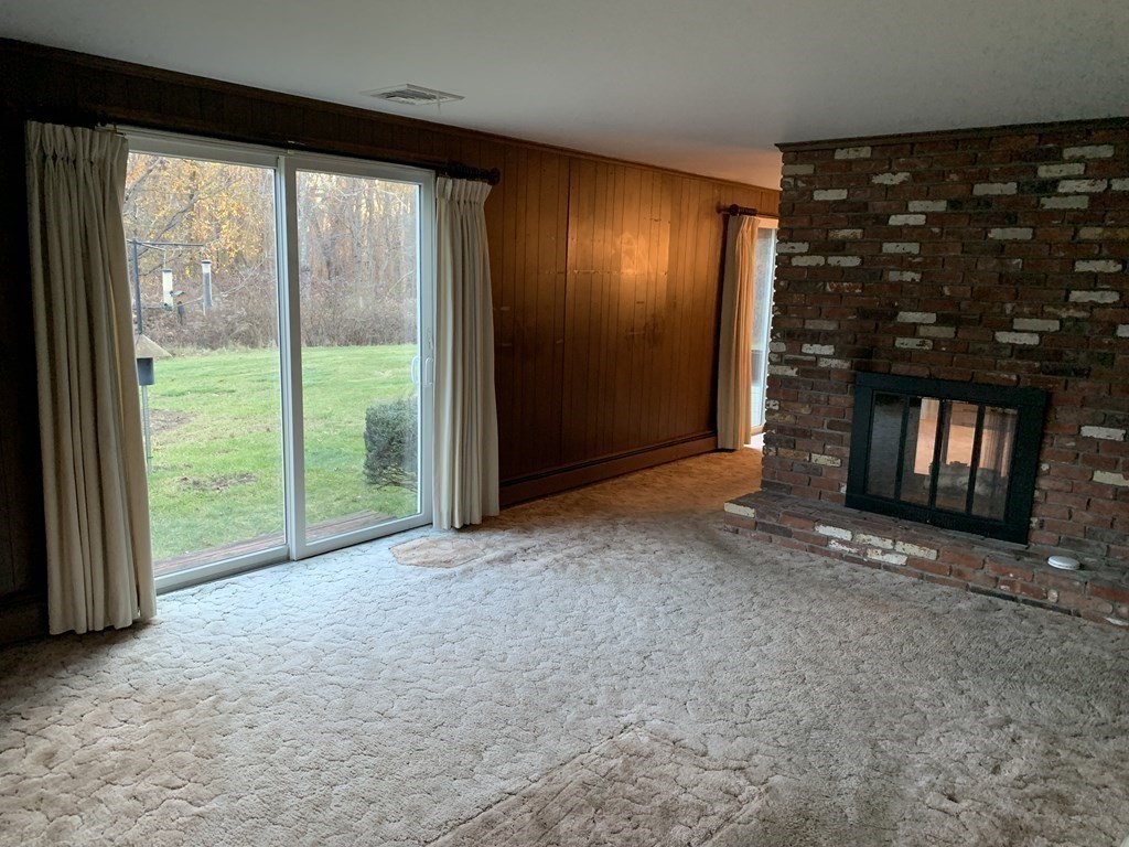 144 Harvard Road Stow, MA 01775 - Photo 15 of 40 a view of an empty room with window and fire place