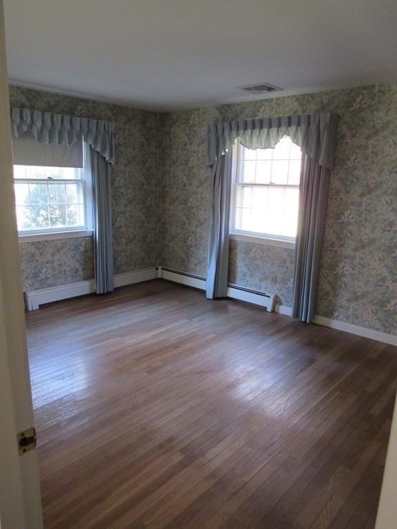 144 Harvard Road Stow, MA 01775 - Photo 20 of 40 an empty room with wooden floor and windows