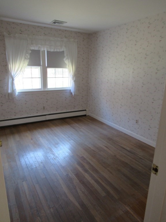 144 Harvard Road Stow, MA 01775 - Photo 21 of 40 an empty room with wooden floor and windows