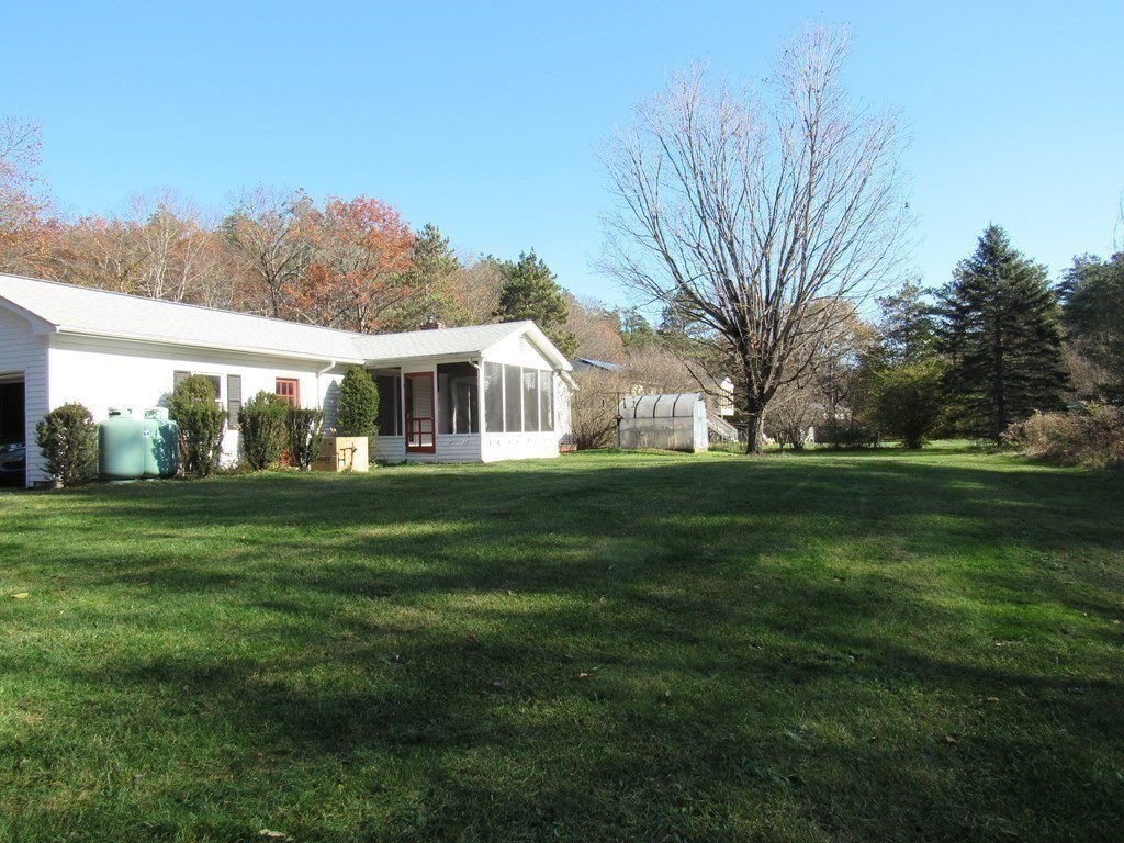 144 Harvard Road Stow, MA 01775 - Photo 23 of 40 a front view of a house with a yard