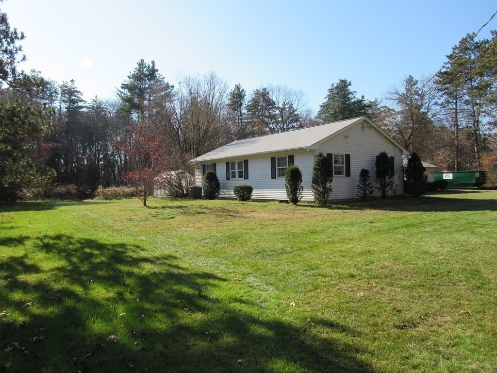 144 Harvard Road Stow, MA 01775 - Photo 31 of 40 a front view of house with yard and green space