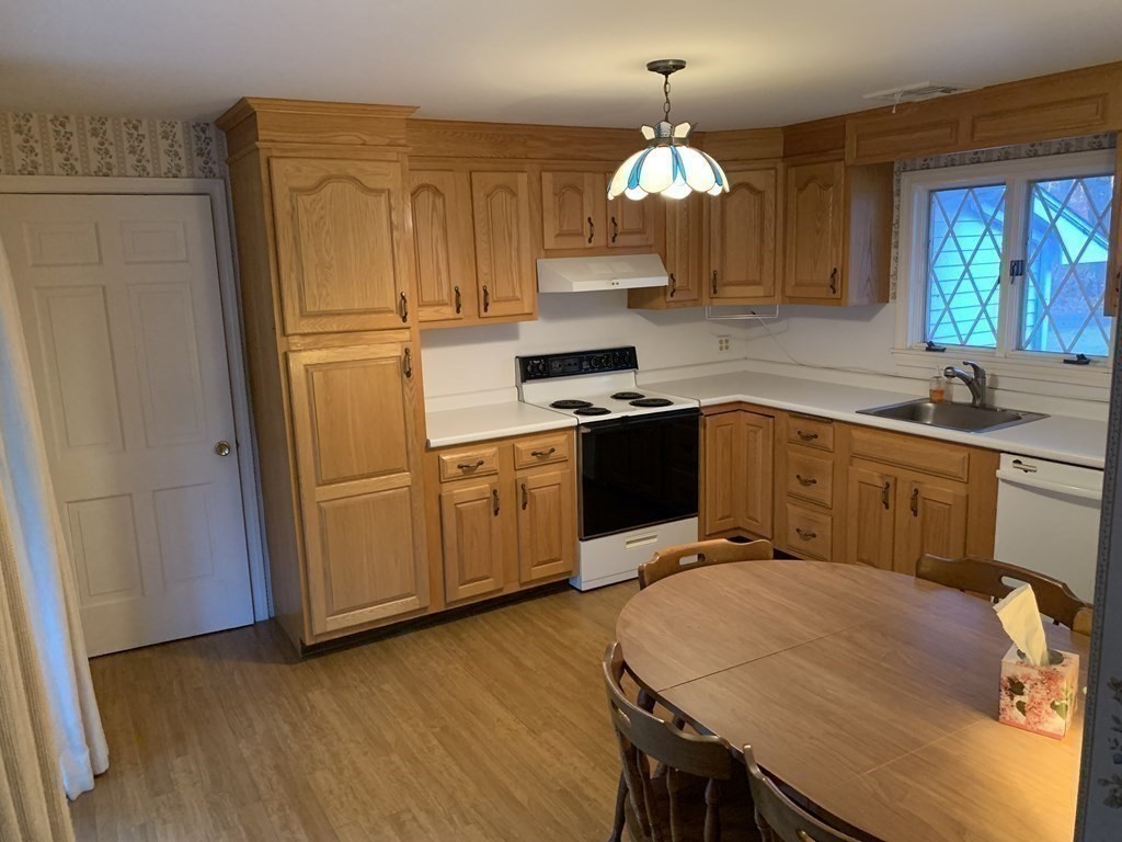 144 Harvard Road Stow, MA 01775 - Photo 8 of 40 a kitchen with wooden cabinets and sink