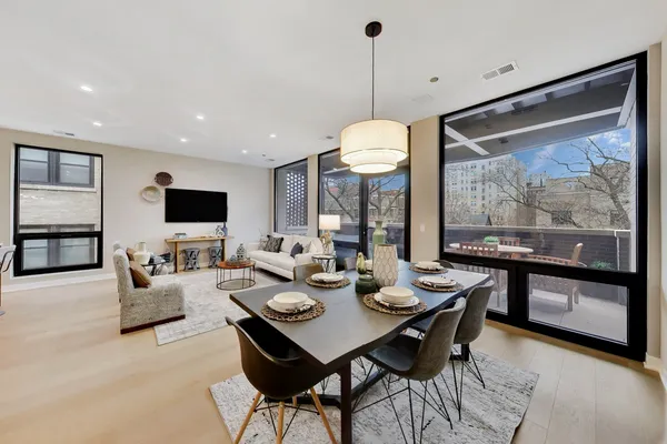 a view of a dining room with a table and chairs