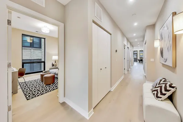 a spacious bedroom with a bed and glass windows