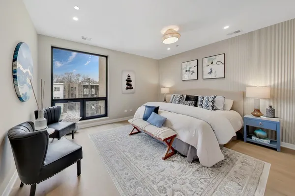 a bedroom with a bed and a chandelier