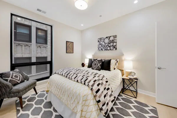 a bedroom with a bed and wooden floor