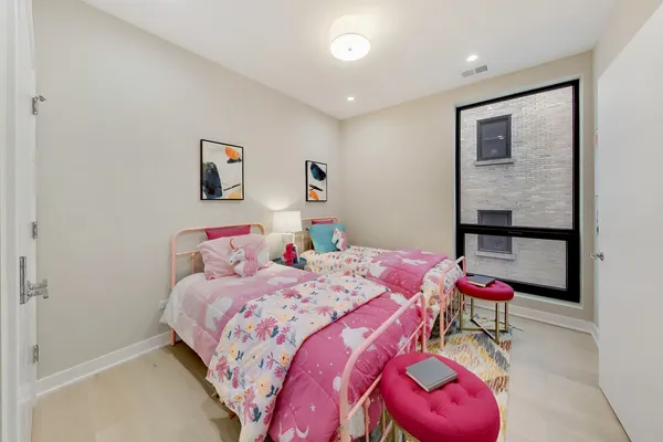 a bedroom with three beds and painted walls