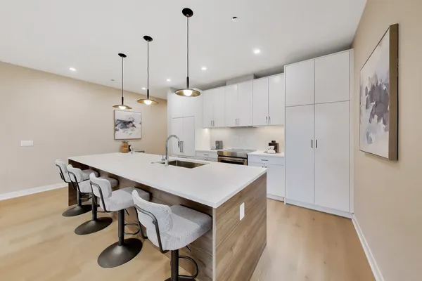 a kitchen with stainless steel appliances granite countertop a sink and a stove