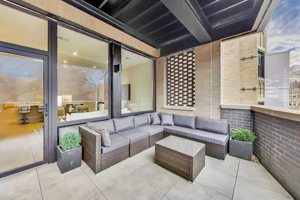 a living room with furniture and a floor to ceiling window