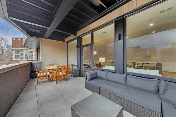 a balcony with chairs and stove