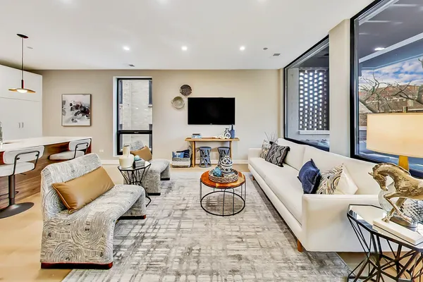 a living room with furniture kitchen and a view of kitchen