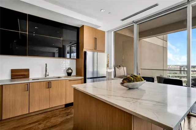 a kitchen with stainless steel appliances a sink a stove and a refrigerator
