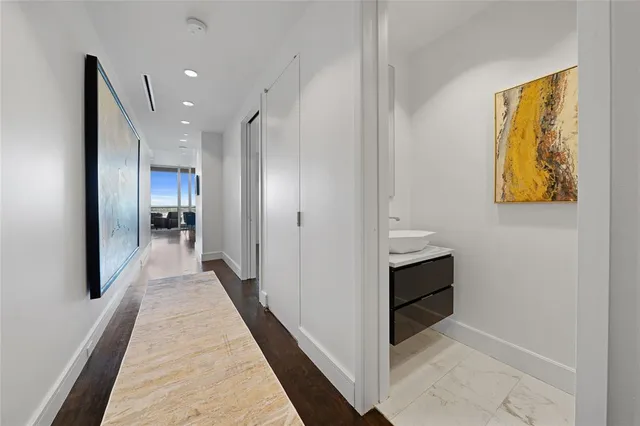 a view of hallway with wooden floor