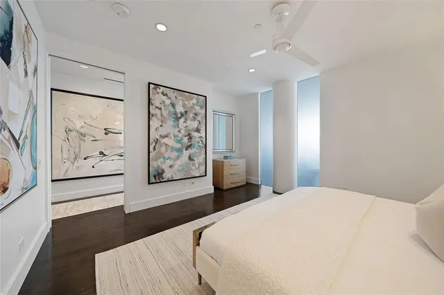 a bedroom with a large bed and a large window