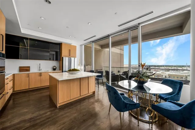 a kitchen with a table chairs stove and kitchen view