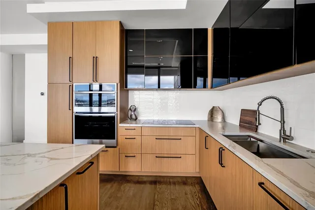 a kitchen with stainless steel appliances granite countertop a sink and a stove