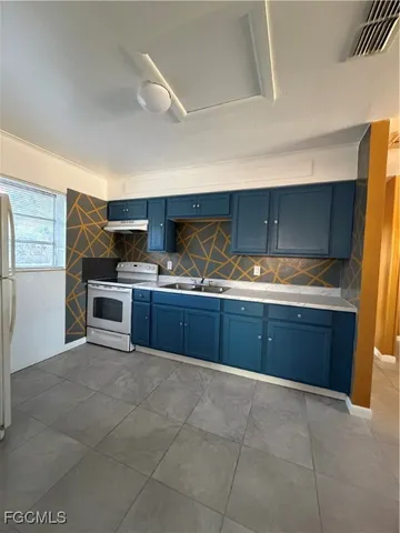 a kitchen with a sink and cabinets