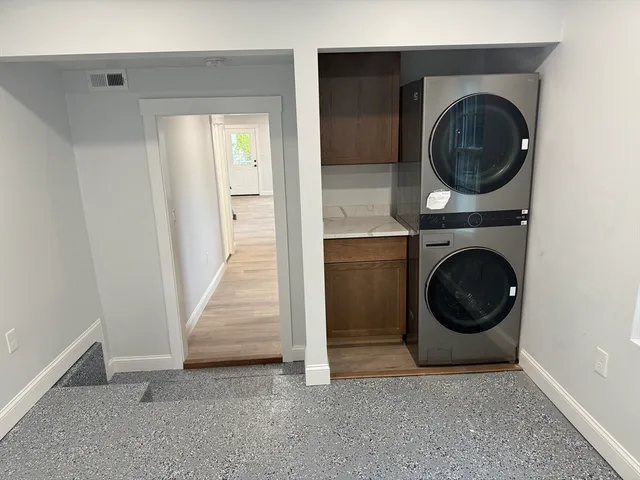 a view of a storage and utility room with washer and dryer