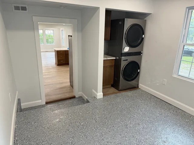 a view of a hallway with wooden floor and stairs
