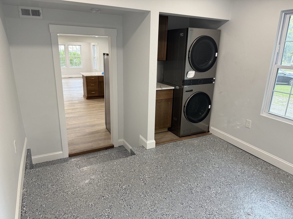 27 Leicester Street, Unit 1 Oxford, MA 01537 - Photo 14 of 26 a view of a storage and utility room with washer and dryer