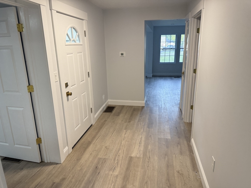 27 Leicester Street, Unit 1 Oxford, MA 01537 - Photo 15 of 26 a view of a hallway with wooden floor and stairs