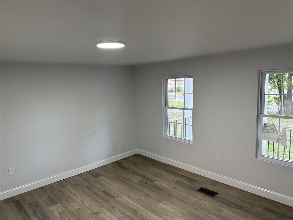 27 Leicester Street, Unit 1 Oxford, MA 01537 - Photo 23 of 26 an empty room with wooden floor and windows