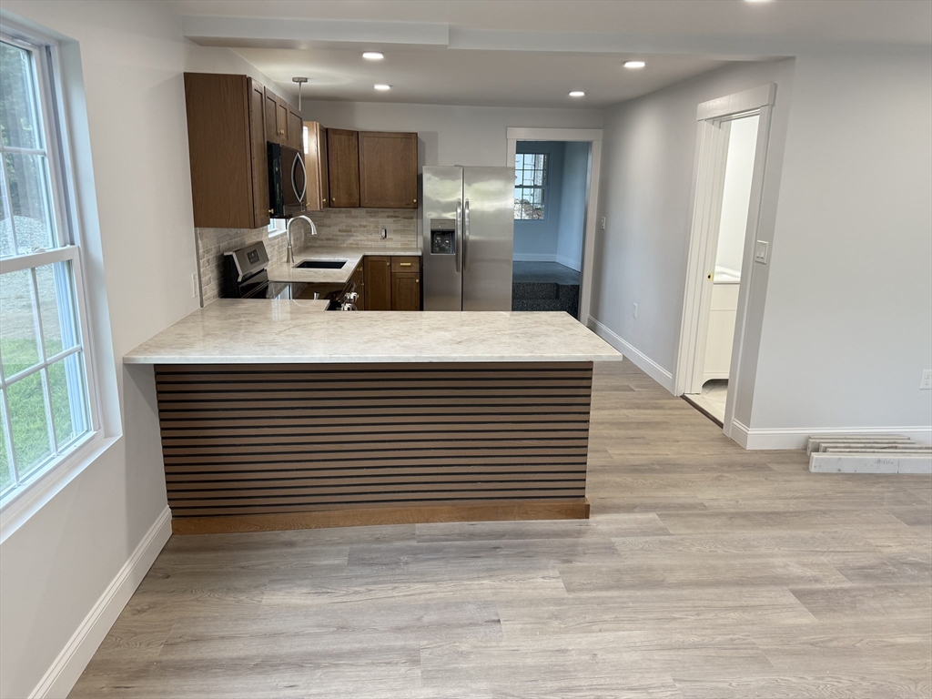 27 Leicester Street, Unit 1 Oxford, MA 01537 - Photo 4 of 26 a view of kitchen with stainless steel appliances kitchen island sink and refrigerator