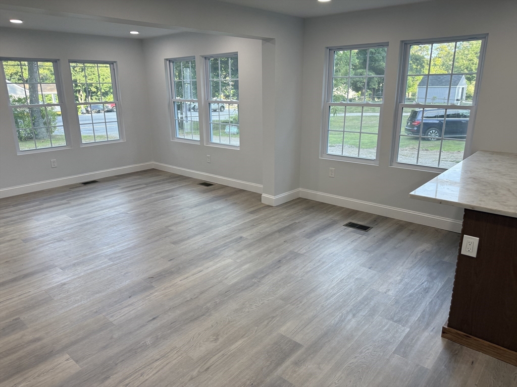 27 Leicester Street, Unit 1 Oxford, MA 01537 - Photo 8 of 26 an empty room with wooden floor and windows
