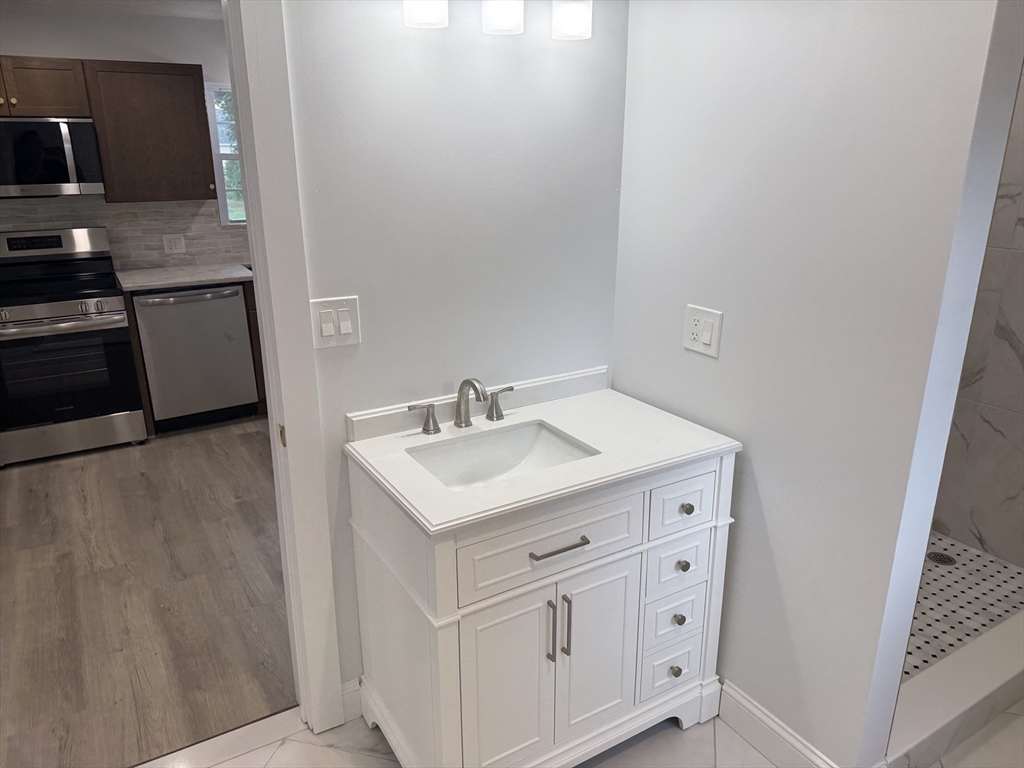 27 Leicester Street, Unit 1 Oxford, MA 01537 - Photo 9 of 26 a utility room with cabinets washer and dryer