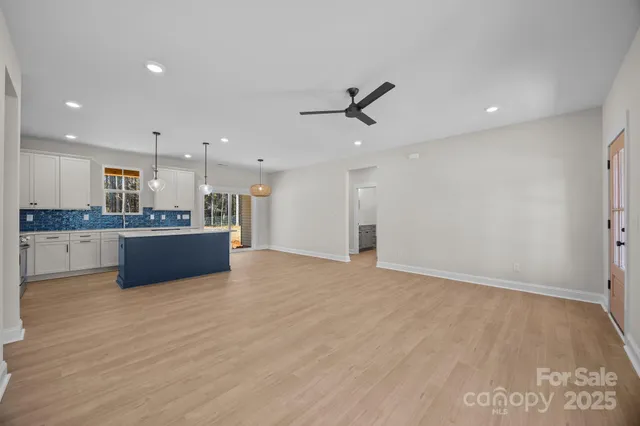 a view of kitchen with refrigerator and window