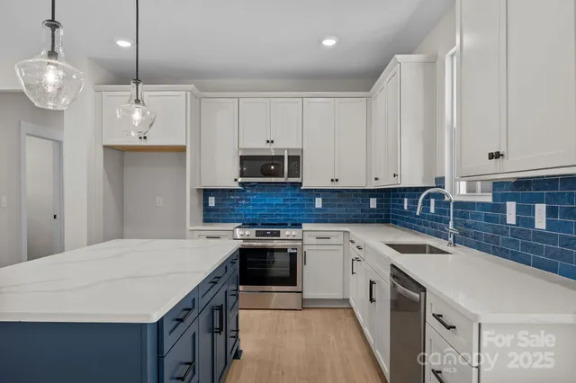 a kitchen with a sink a stove a refrigerator and cabinets