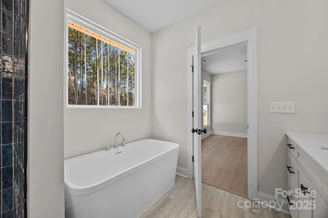 a white bath tub sitting next to a shower