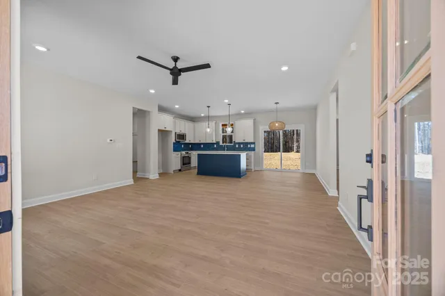 a view of a livingroom with kitchen and furniture
