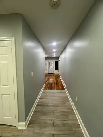 a view of entryway and hall with wooden floor