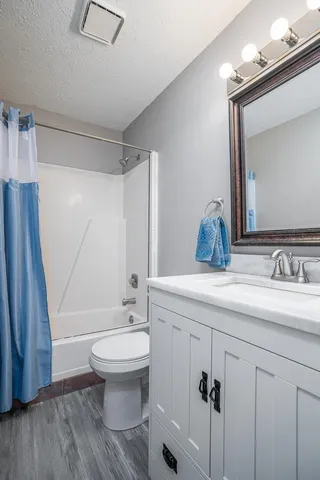 a bedroom with a bed and a dresser