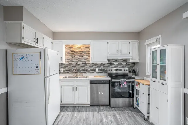 a kitchen with stainless steel appliances granite countertop a stove and a refrigerator