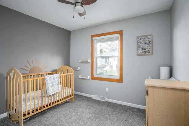 a view of a closet area with mirror and door