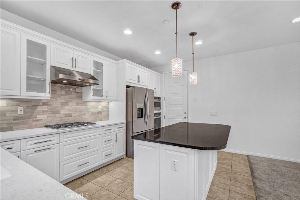 54 Visionary Irvine, CA 92618 - Photo 11 of 39 a kitchen with stainless steel appliances granite countertop a sink a stove and a refrigerator