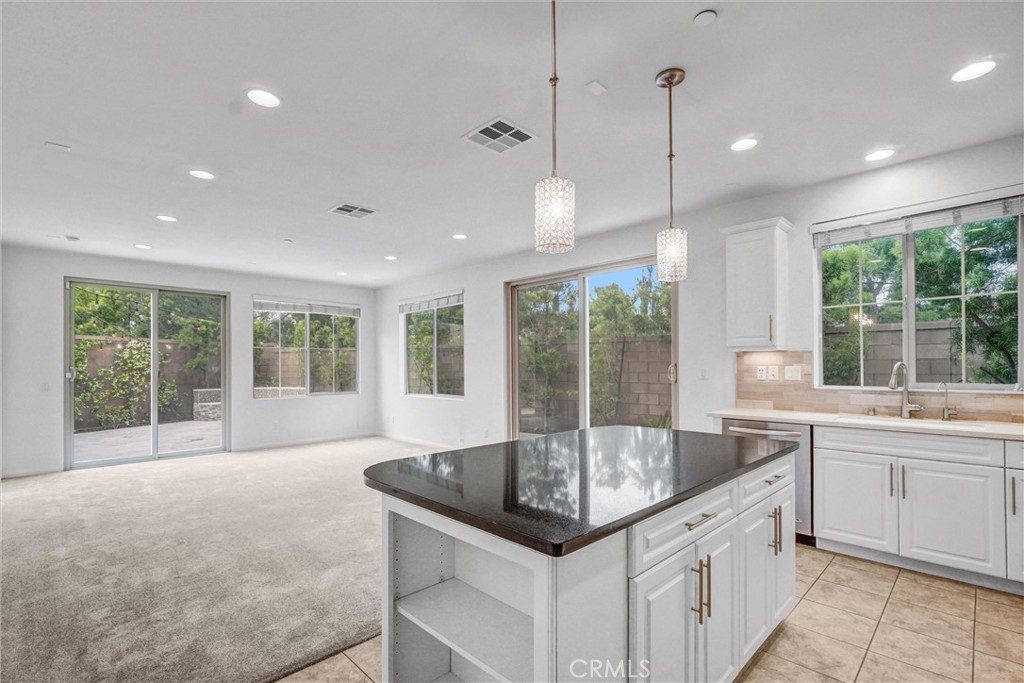 54 Visionary Irvine, CA 92618 - Photo 13 of 39 a kitchen with granite countertop a sink and white cabinets