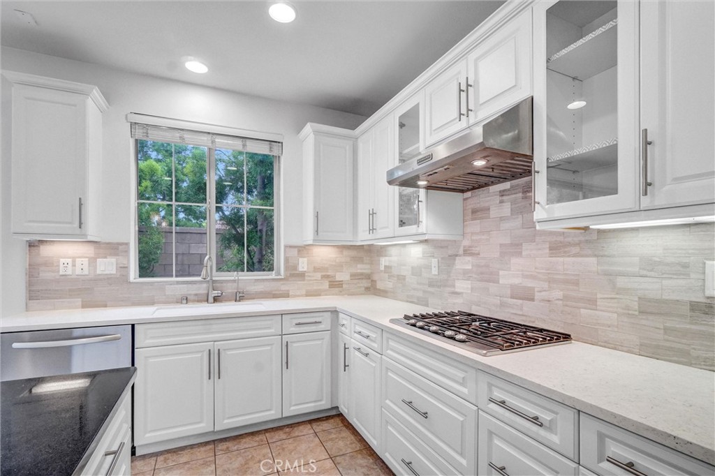 54 Visionary Irvine, CA 92618 - Photo 14 of 39 a kitchen with cabinets appliances a sink and a window