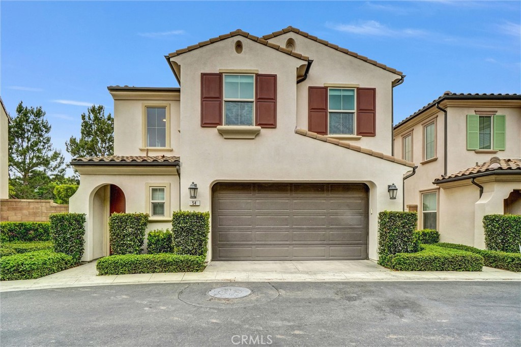 54 Visionary Irvine, CA 92618 - Photo 2 of 39 a front view of a house with a yard and garage