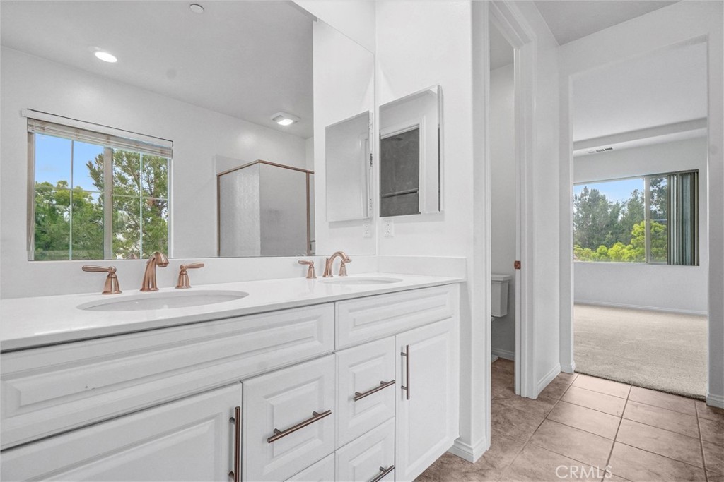 54 Visionary Irvine, CA 92618 - Photo 21 of 39 a bathroom with a sink and a mirror
