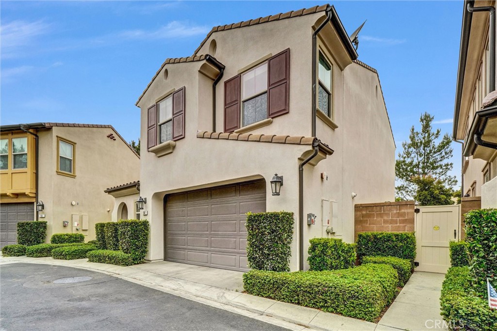 54 Visionary Irvine, CA 92618 - Photo 4 of 39 a front view of a house with a yard and garage