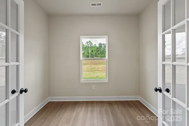 wooden floor and window in an empty room