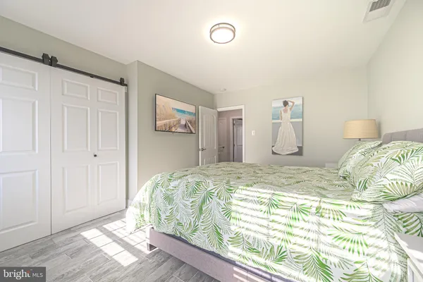 a bed sitting in a bedroom next to a cabinet